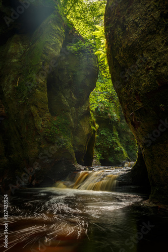 Inside of the Devil’s Pulpit gorge, with running water, Dumgoyne, Scotland, UK