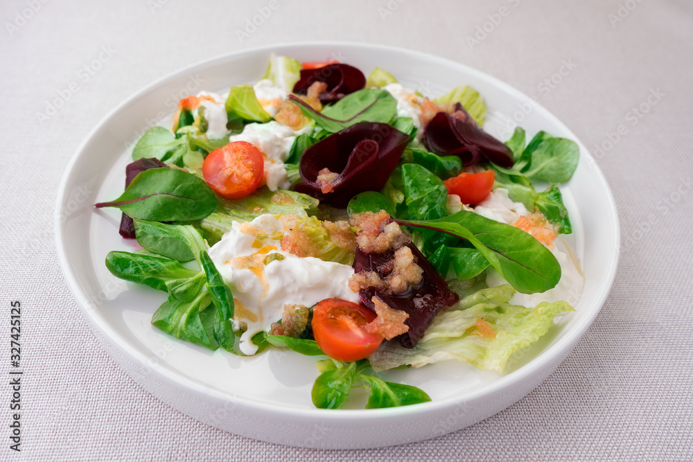 Vegetarian salad of tomatoes, beets, lettuce,