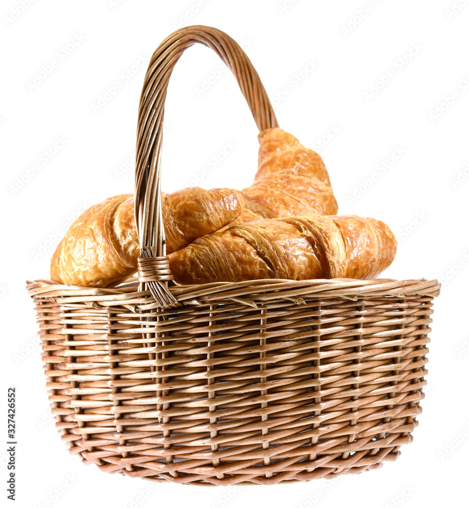 Fresh croissants in the basket isolated on white