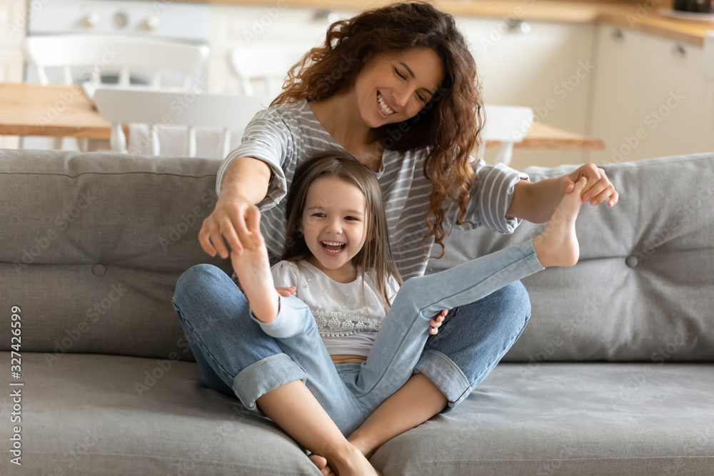 Happy mother playing with small girl at home Happy mother playing with small girl at home