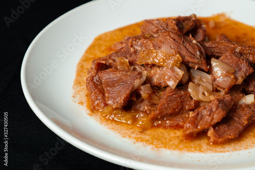 Greek dish Stifado, made with lamb and served with Greek salad. Can also be made with beef or game