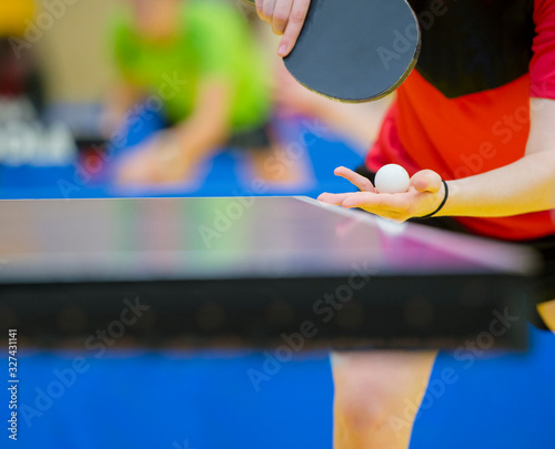 Close up of a woman hands holding table tennis rocket and ball