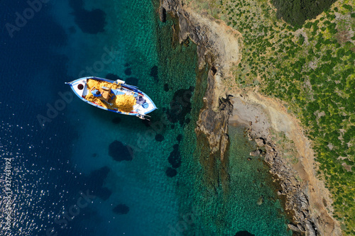 Fototapeta Naklejka Na Ścianę i Meble -  Aerial drone photo of beautiful traditional fishing boat in island of Crete at spring, Greece
