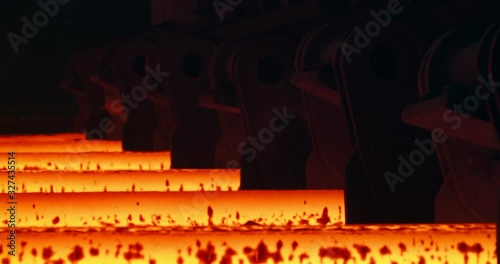 Iron foundry. Continuous casting machine. Steel billet moving through the pipeline.