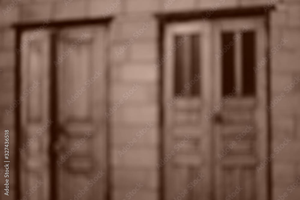 Two old wooden doors and wall, blurred sepia photo Two old wooden doors and wall, blurred sepia photo