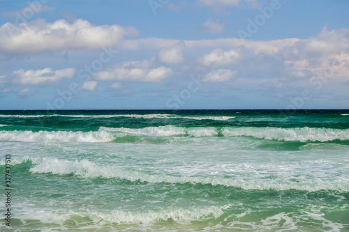 Deep green waves rolling into shore