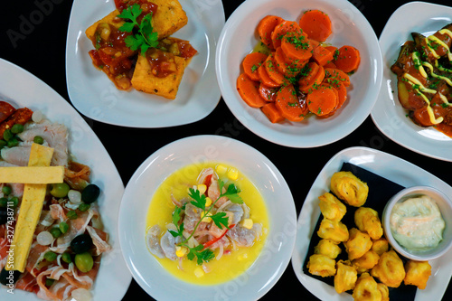 spanish tapas. tapa is an appetizer or snack in Spanish cuisine and translates to small portion of any kind of Spanish cuisine, marinated carrot,seafood,calamari etc