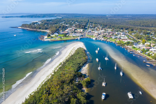 Aerial drone view of boats and yachts moored on Currambene Creek at Huskisson, Jervis Bay on the New South Wales South Coast, Australia, on a bright sunny day 