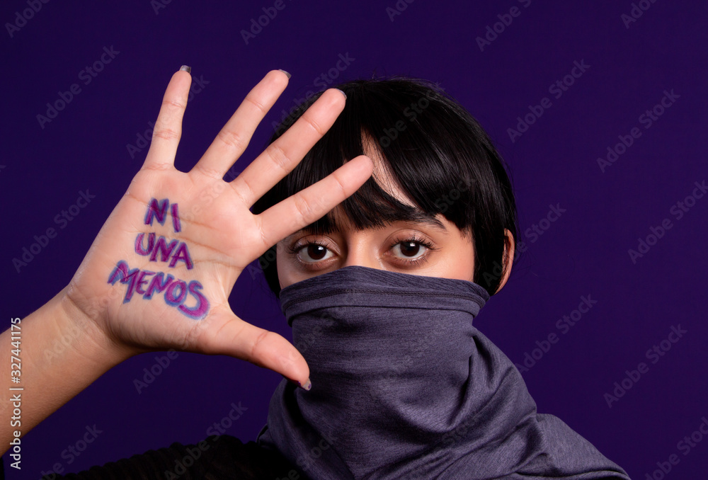 Covered face Latin girl protesting against gender injustice Covered face Latin girl protesting against gender injustice