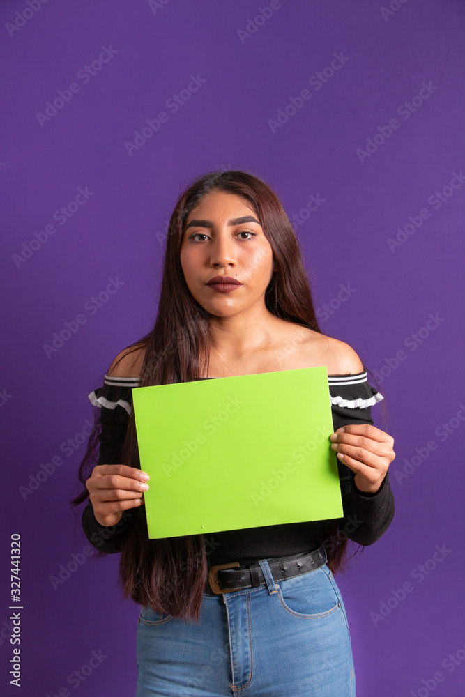 Young ethnic girl presenting an empty green screen board Young ethnic girl presenting an empty green screen board