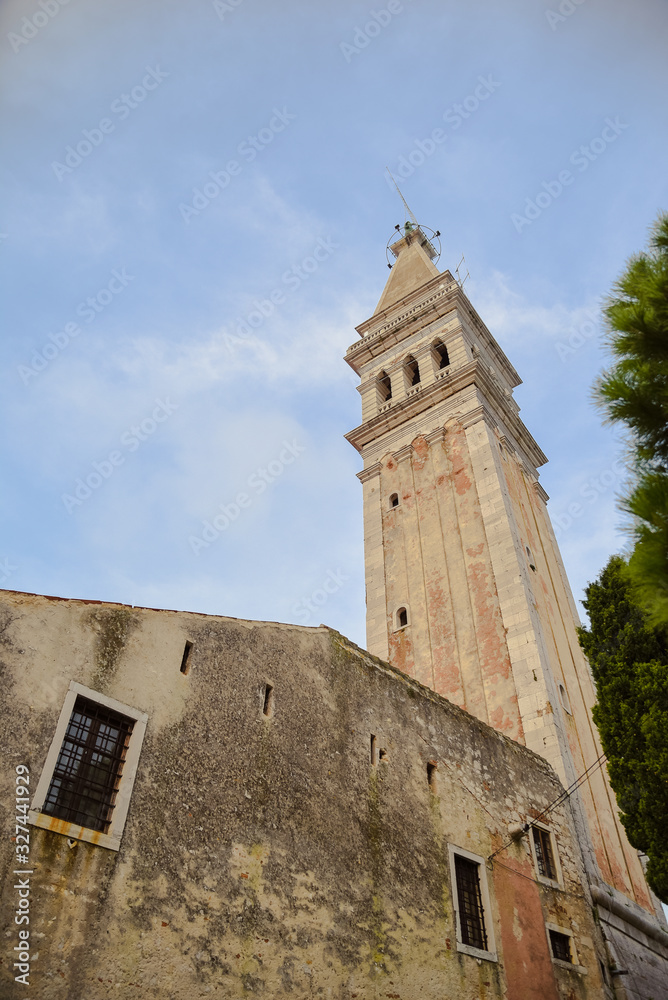 Low angle shot of baroque style tower of St. Euphemia church in Rovinj Istria Croatia during noon of the sunny summer day
