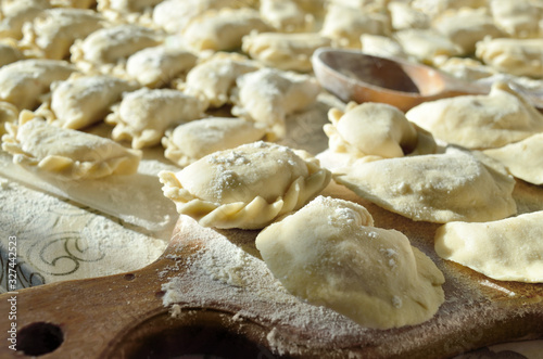 Dumplings, ravioli with cheese are on the kitchen table
