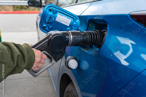 Everett WA. - USA / 02/25/2020: Prius Hybrid Car Being Fueled Up With Gasoline