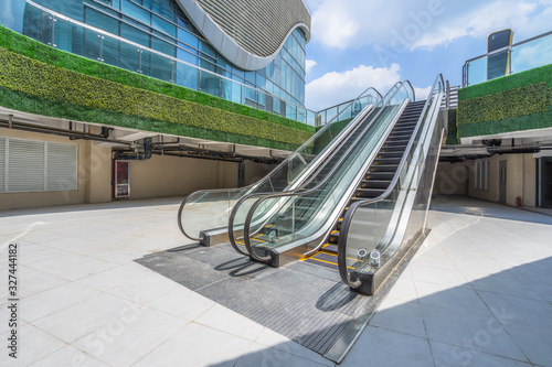 the escalator with modern buildings in the cityscape.