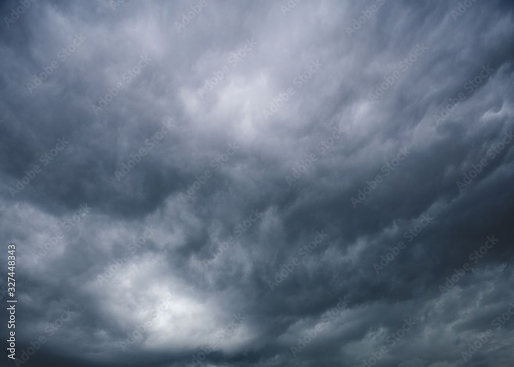 contrasting blue sky with clouds with storm rolling in contrasting blue sky with clouds with storm rolling in
