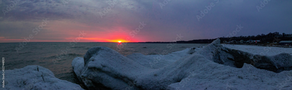 Panorama of sunset at Port Stanley in the Winter time. Visible snow and waves.
