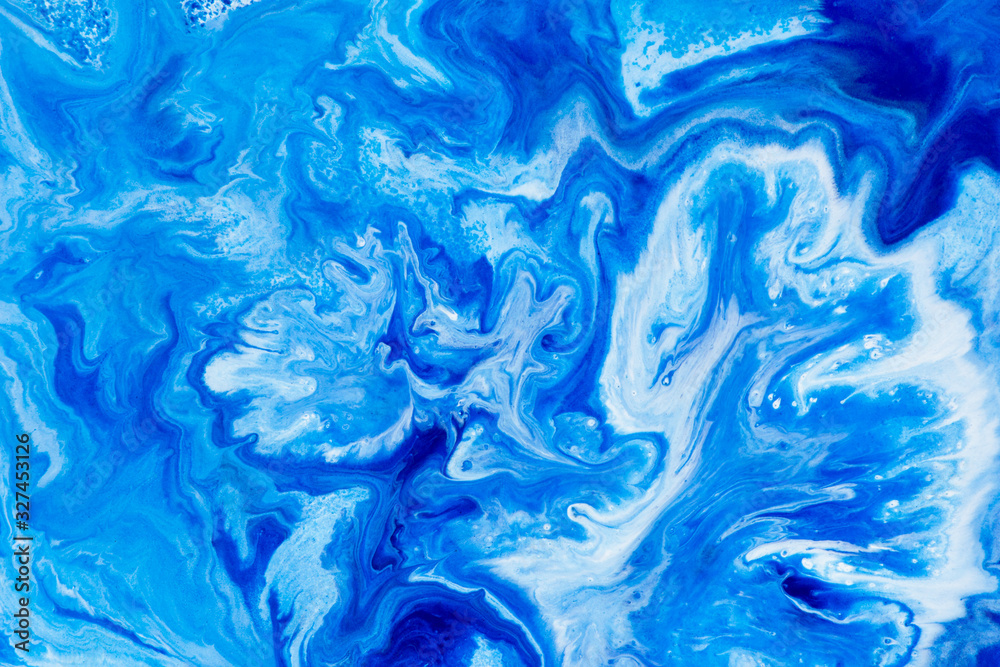 Classic blue and white watercolor paint in abstract striped swirling blurry shapes for design. An interesting unusual beautiful background in macro from streaks of spread mixed paint. Blurry paint.
