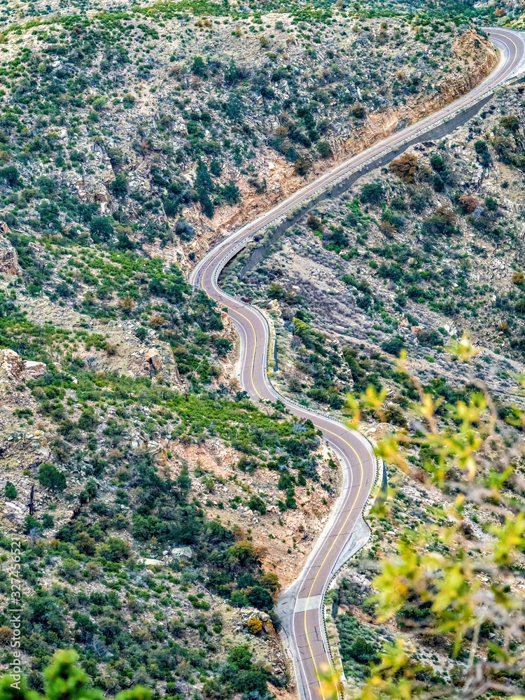 road through desert mountain viewed from above