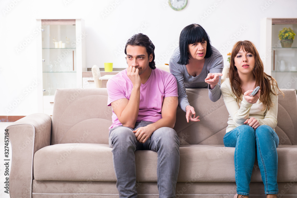 Young family and mother-in-law in family issues concept Young family and mother-in-law in family issues concept