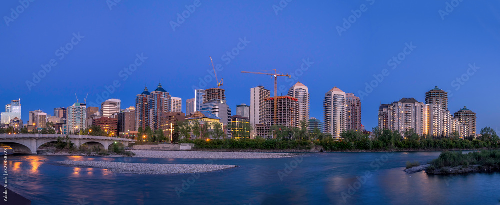 Calgary's skyline at dusk along the Bow River. Office and condominiums visible. 