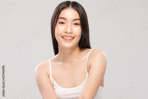 Beautiful Asian woman looking at camera smile with clean and fresh skin Happiness and cheerful with positive emotional,isolated on white background,Beauty and Cosmetics Concept © 220 Selfmade studio