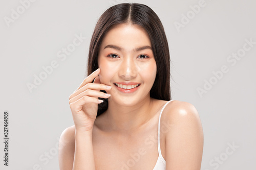 Beautiful Asian woman touching soft cheek smile with clean and fresh skin Happiness and cheerful with positive emotional,isolated on white background,Beauty and Cosmetics Concept © 220 Selfmade studio