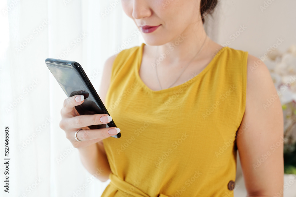 Close-up image of woman checking messages and notifications on smartphone Close-up image of woman checking messages and notifications on smartphone
