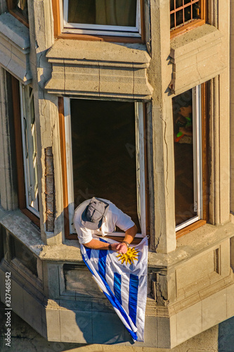 Man at Balcony with Uruguayan Flag photo