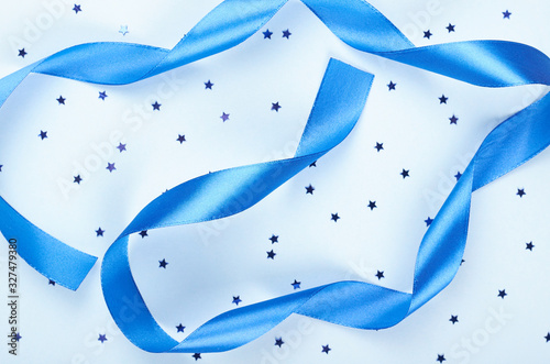 Decorative blue ribbon flat lay.