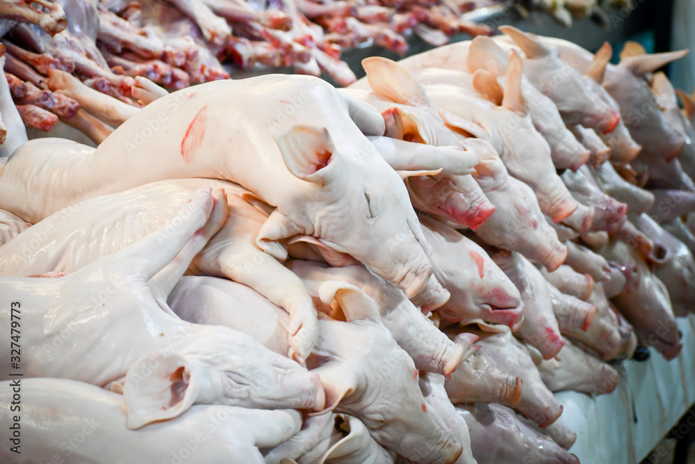 Obraz premium Baby or sucker porks stacked in a Mexican market for sell.