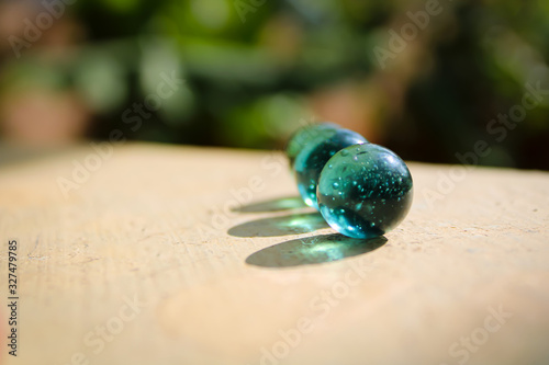 	2. Two glass green marble ball with a nice shadow and good lighting with blur green background