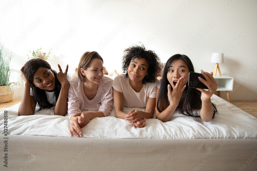 Beautiful Asian woman taking selfie with friends at sleepover party Beautiful Asian woman taking selfie with friends at sleepover party