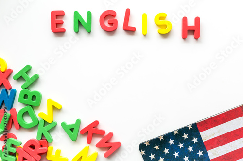English text near American flag and letters on white background top-down copy space