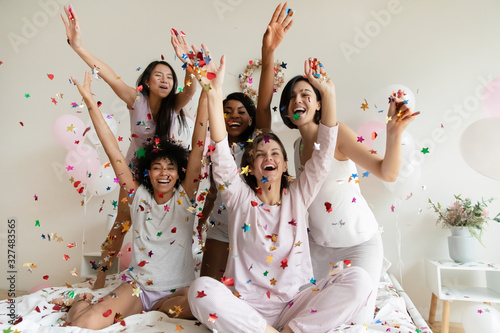 Cuadro en lienzo Excited diverse girls throwing confetti, celebrating at party