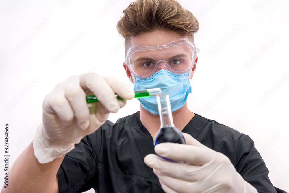 Chemist in protective uniform holding flask and test tube with minerals isolated on white. Science and experiment concept Chemist in protective uniform holding flask and test tube with minerals isolated on white. Science and experiment concept