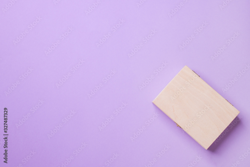 wood box lying on purple background in right corner, top view with copy space wood box lying on purple background in right corner, top view with copy space