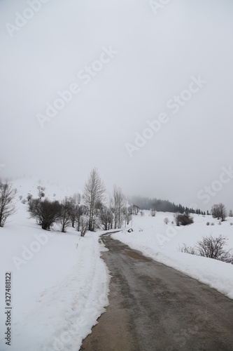 scenic view of empty road with snow covered landscape while snowing in winter season.Savsat/turkey © murat