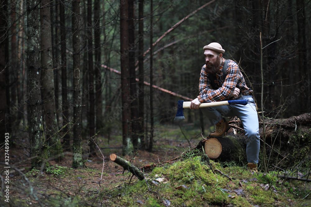 Naklejka premium A bearded lumberjack with a large ax