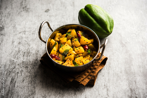 Kaccha Papita Sabji or Raw Papaya Sabzi, served in a karahi or bowl. selective focus photo