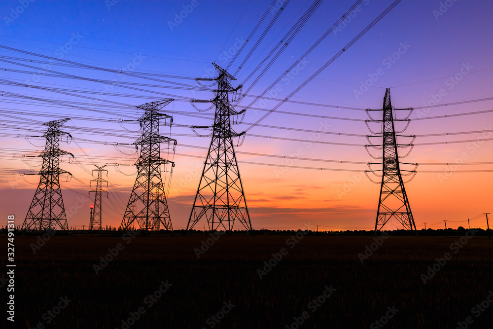 High voltage power tower and beautiful nature landscape at sunset