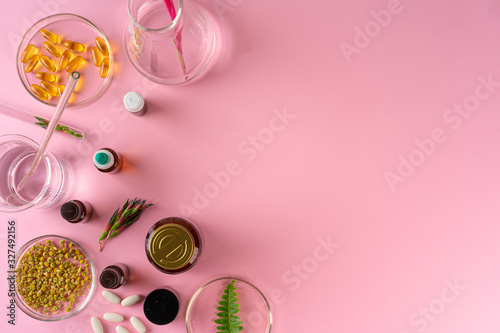 Herbs and Herbal dietary supplements top view on pink background
