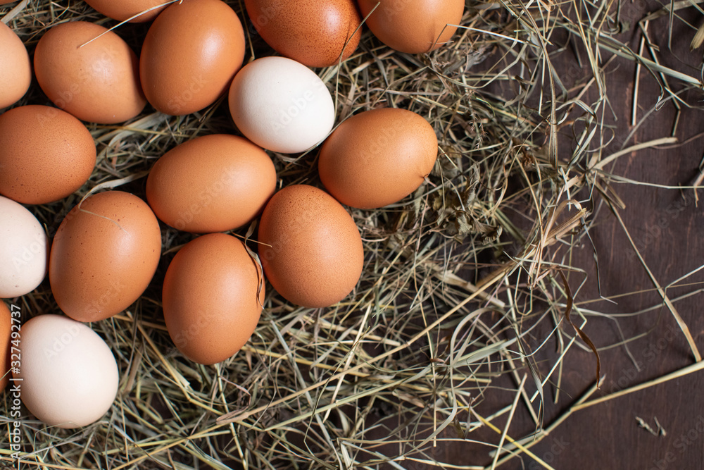 Natural food concept. Household, chicken eggs in nest on hay. Natural food concept. Household, chicken eggs in nest on hay.