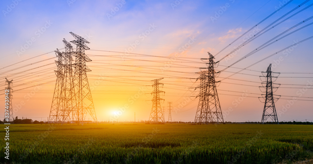 High voltage power tower and beautiful nature landscape at sunset