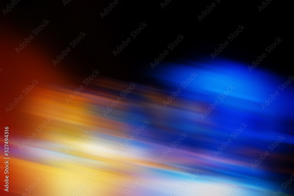 Abstract blurred color blurred dark background, orange, cyan, black and light spots.