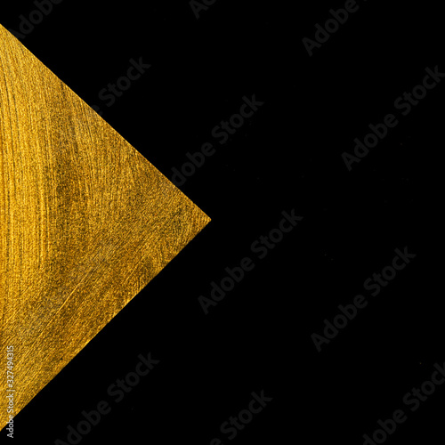 Golden triangle on a black background.