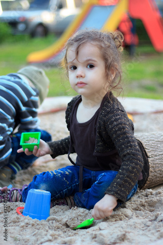Little kid girl playing wit...