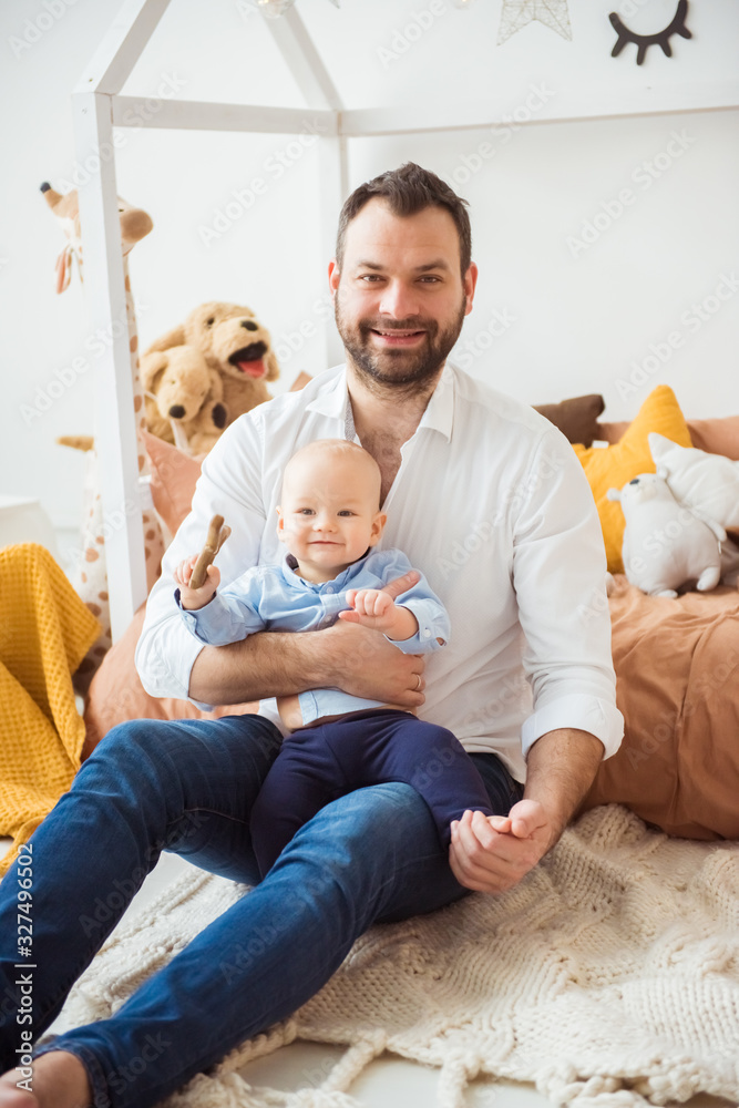 Happy father holding little baby son. Fatherhood concept