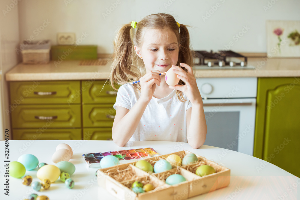 Little girl having fun to paint easter eggs Little girl having fun to paint easter eggs