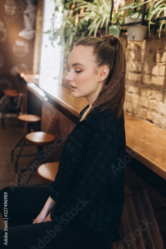 Close up portrait of young fashionable girl in stylish cafe. Youth, new generation, lifestyle concept © Andreshkova Nastya