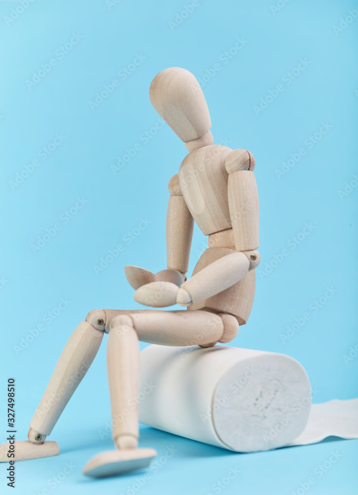 Puppet figures sitting on toilet paper with their stomachs covered Puppet figures sitting on toilet paper with their stomachs covered